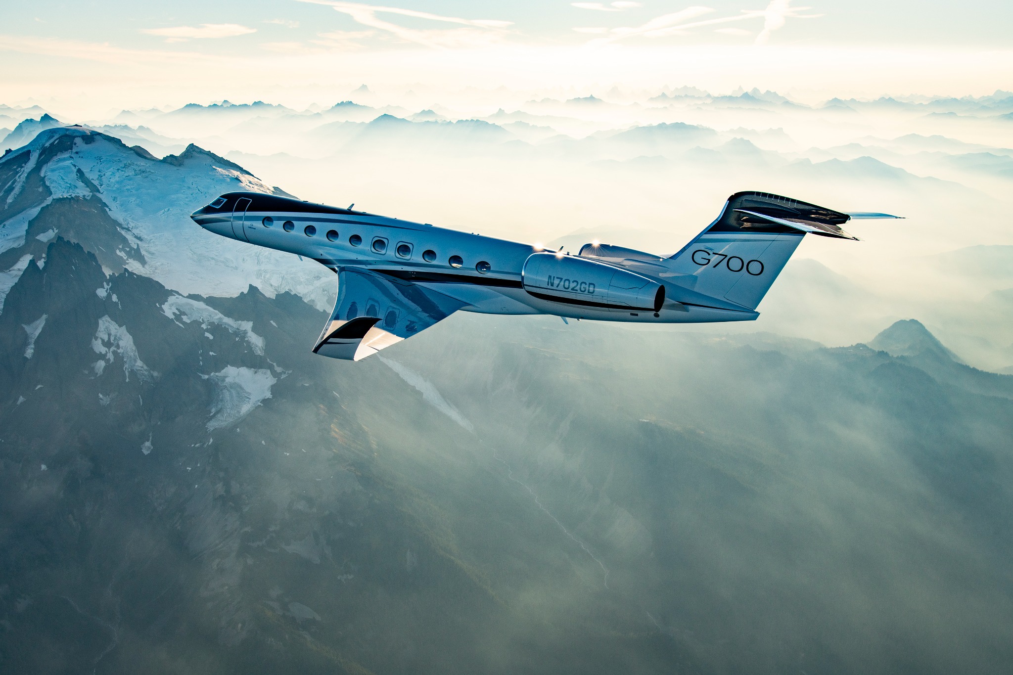 Gulfstream G700 flying above the mountains